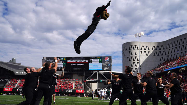 The Cincinnati Bearcats mascot is thrown between cheerleaders in the first quarter during a college football game between the Baylor Bears and the Cincinnati Bearcats, Saturday, Oct. 21, 2023, at Nippert Stadium in Cincinnati.